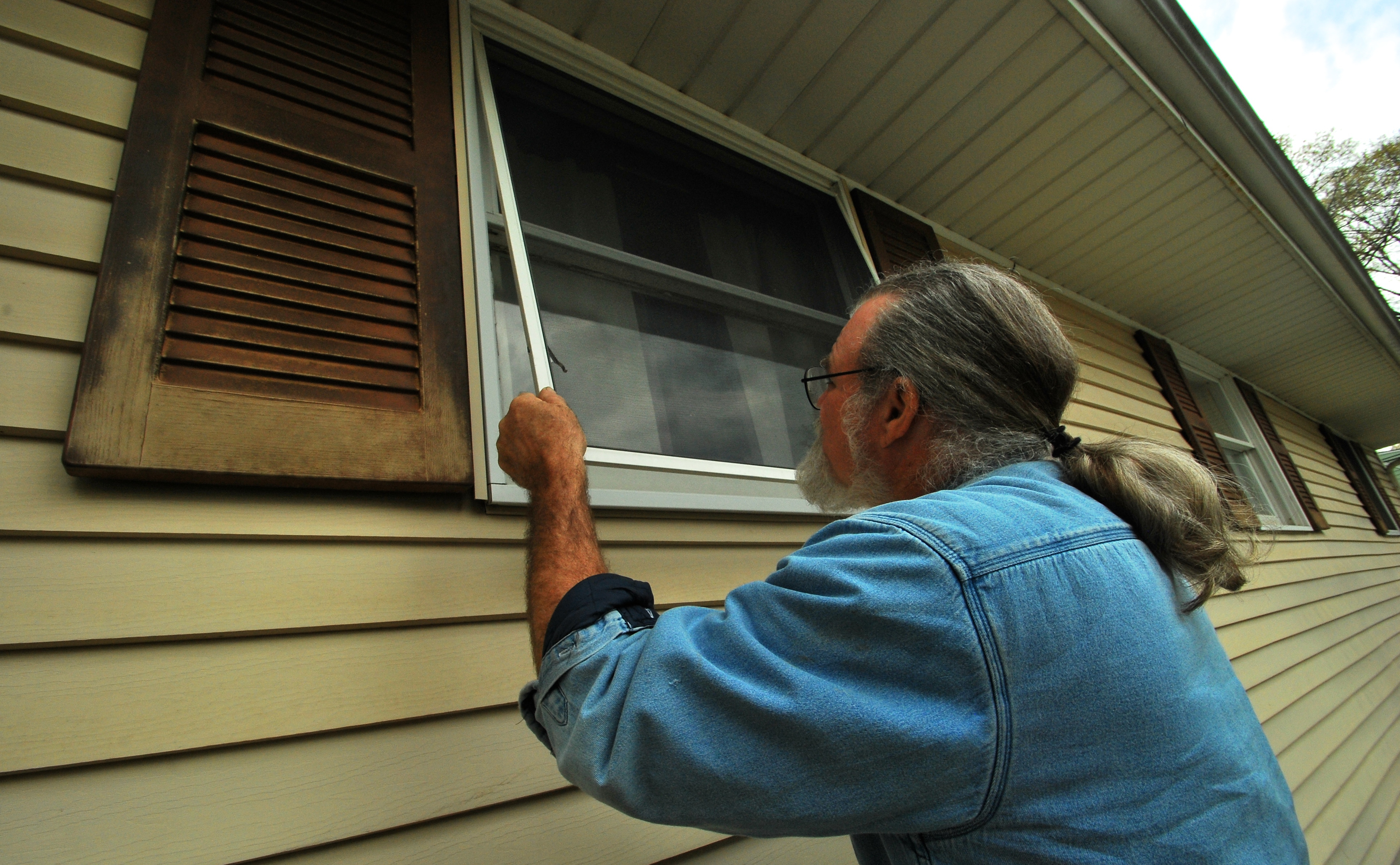 Barry installing a window screen